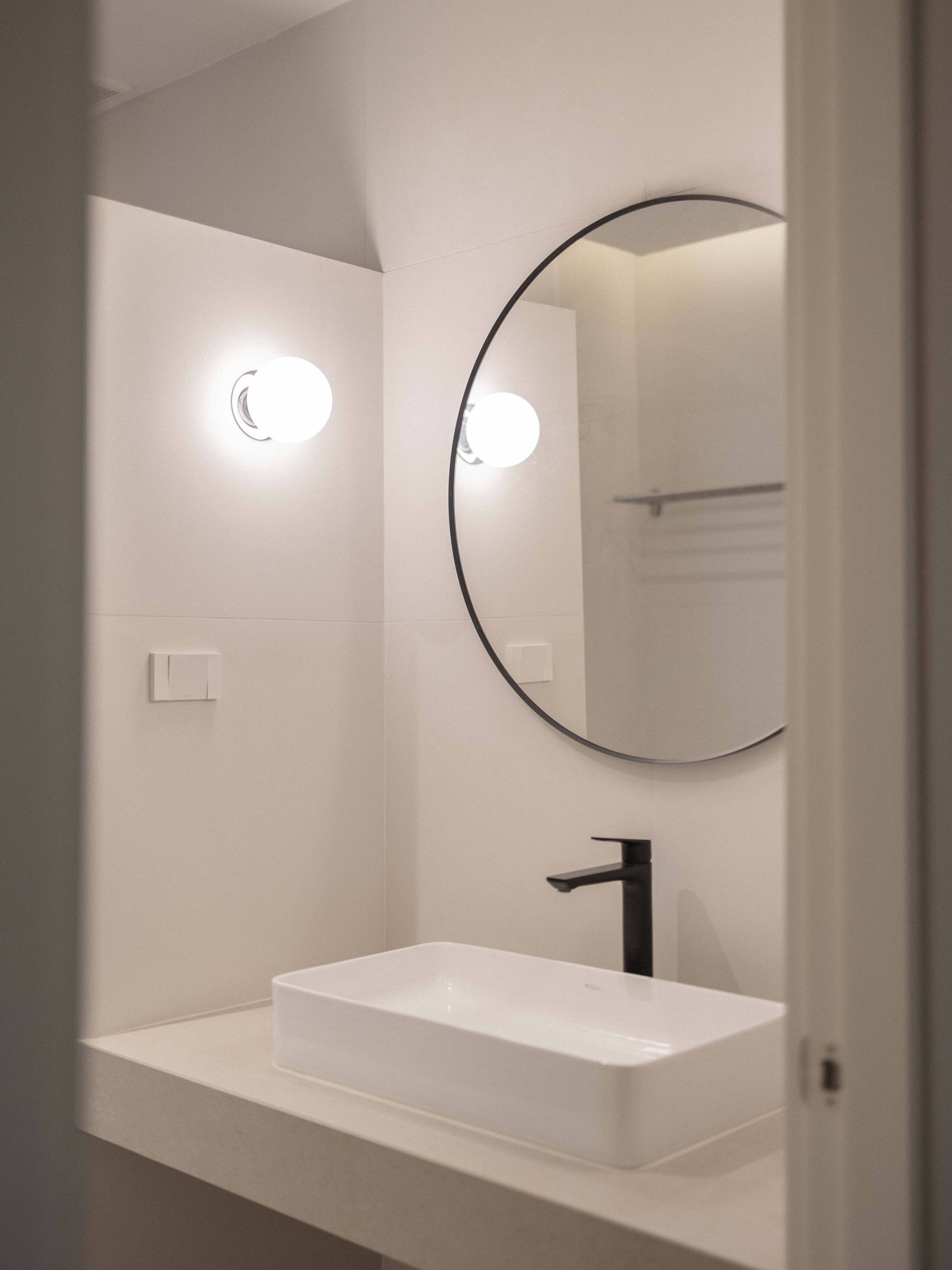 Hallway bathroom vanity with basin and mirror